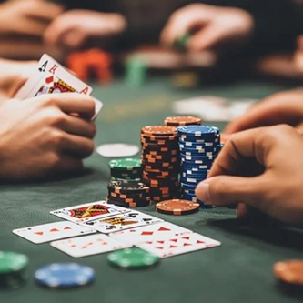 Hands holding cards and chips in a Casino